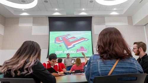 people attending a lecture in the live oak ballroom at the setzer student center